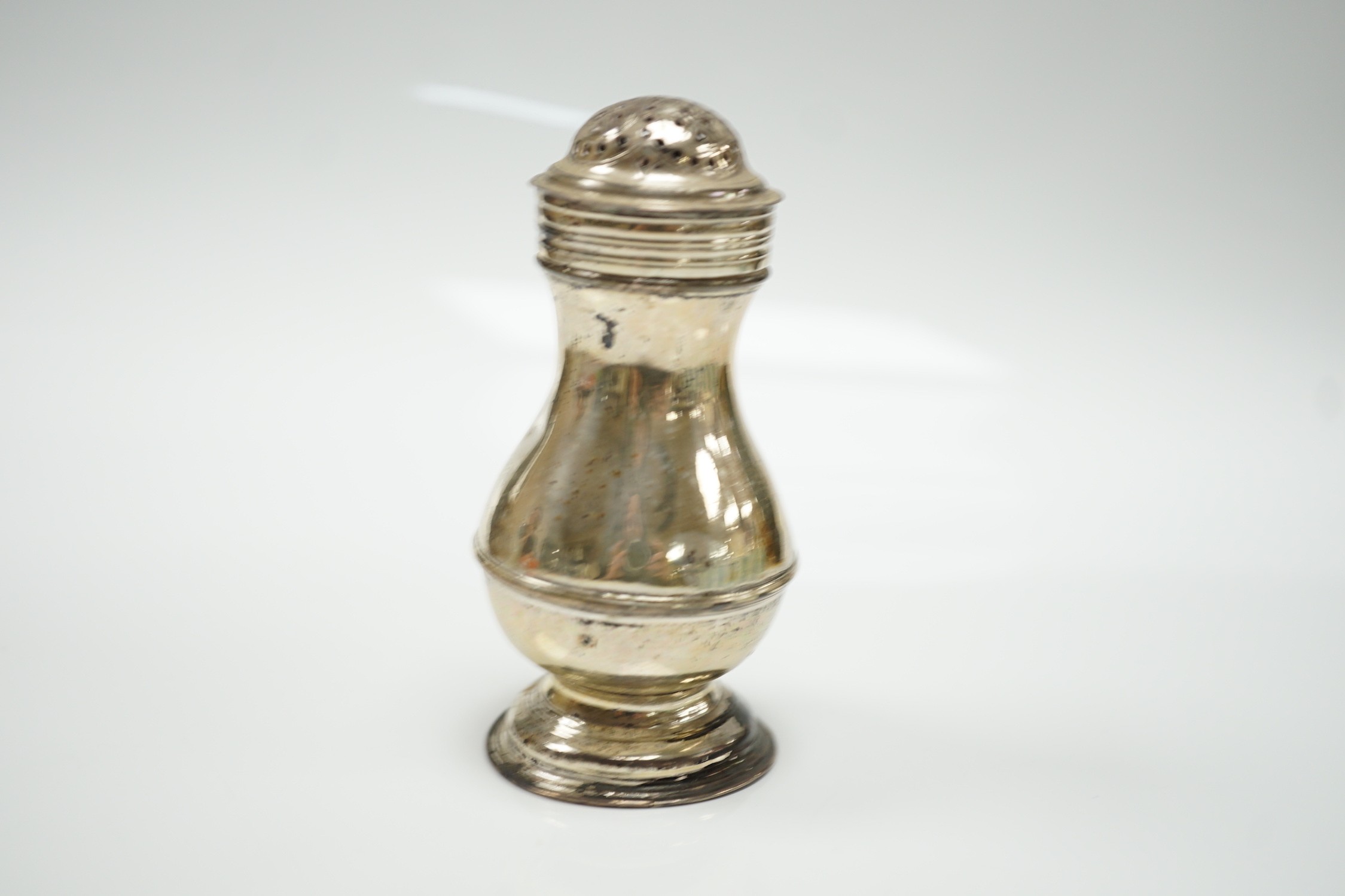 An early George II silver pepperette, maker's mark rubbed, London, 1729, 10cm.